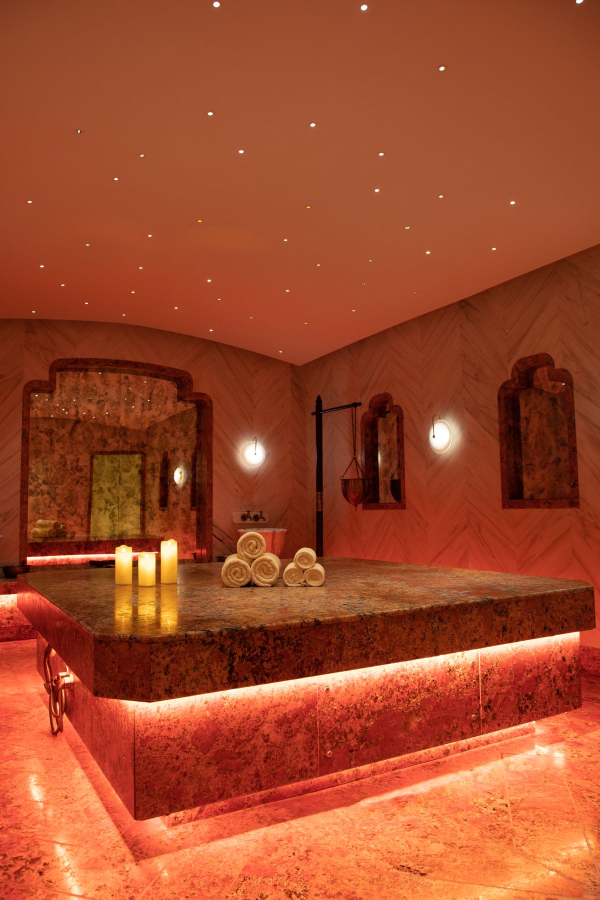 Warm candlelit spa treatment room